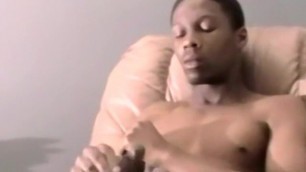 Cute young black amateur strokes his big cock and cums