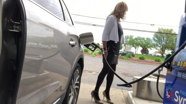 Wild Paula at the Gas Station with zippered dress show'g off